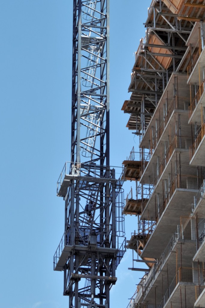 Crane operator climbing tower crane